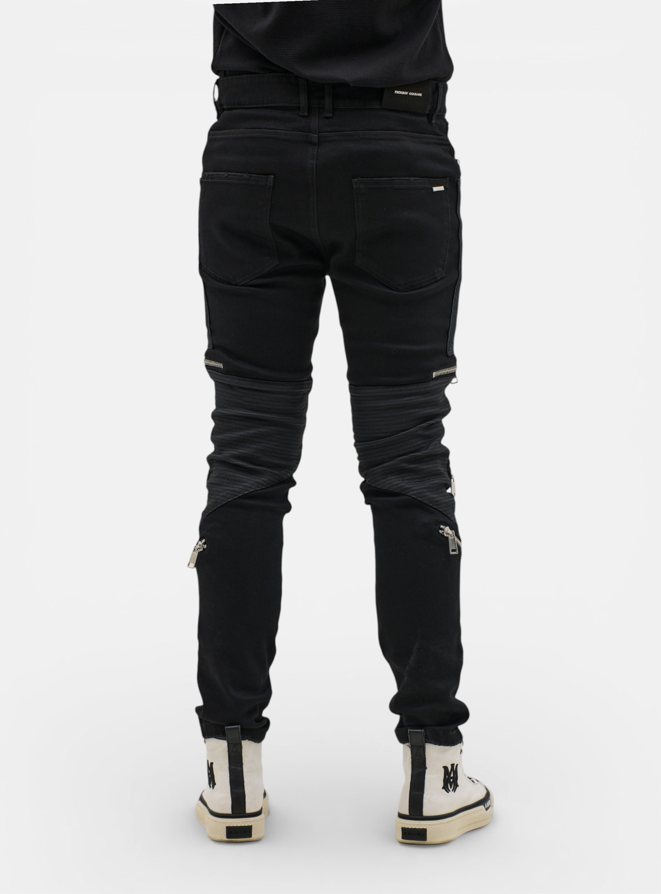 Fxckboy black skinny jeans with techno shield effect, featuring leather-look panels and zip details on the legs.