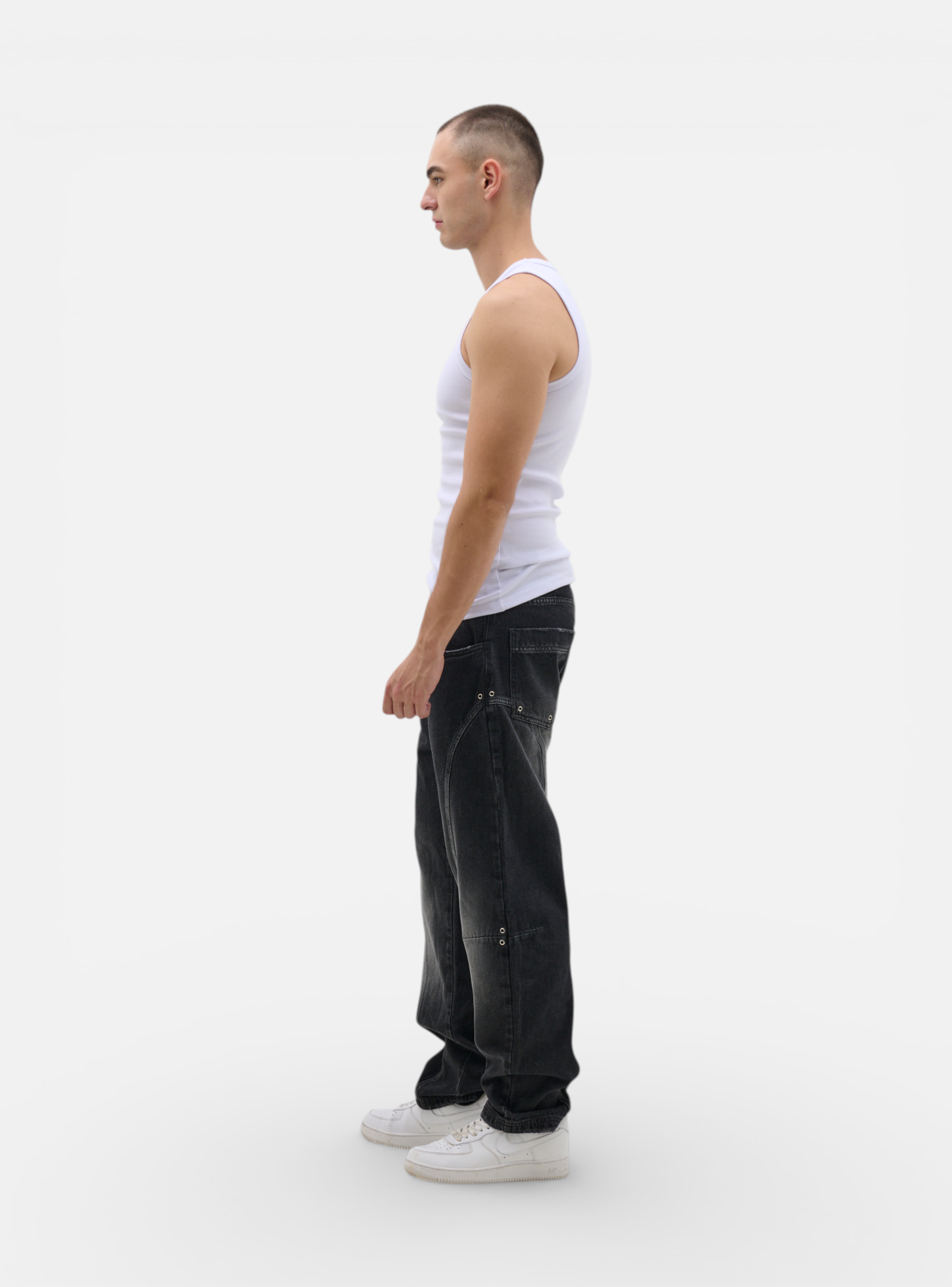 Fxckboy Relaxed System 07 dark grey washed denim jeans with technical design and metal eyelet details.