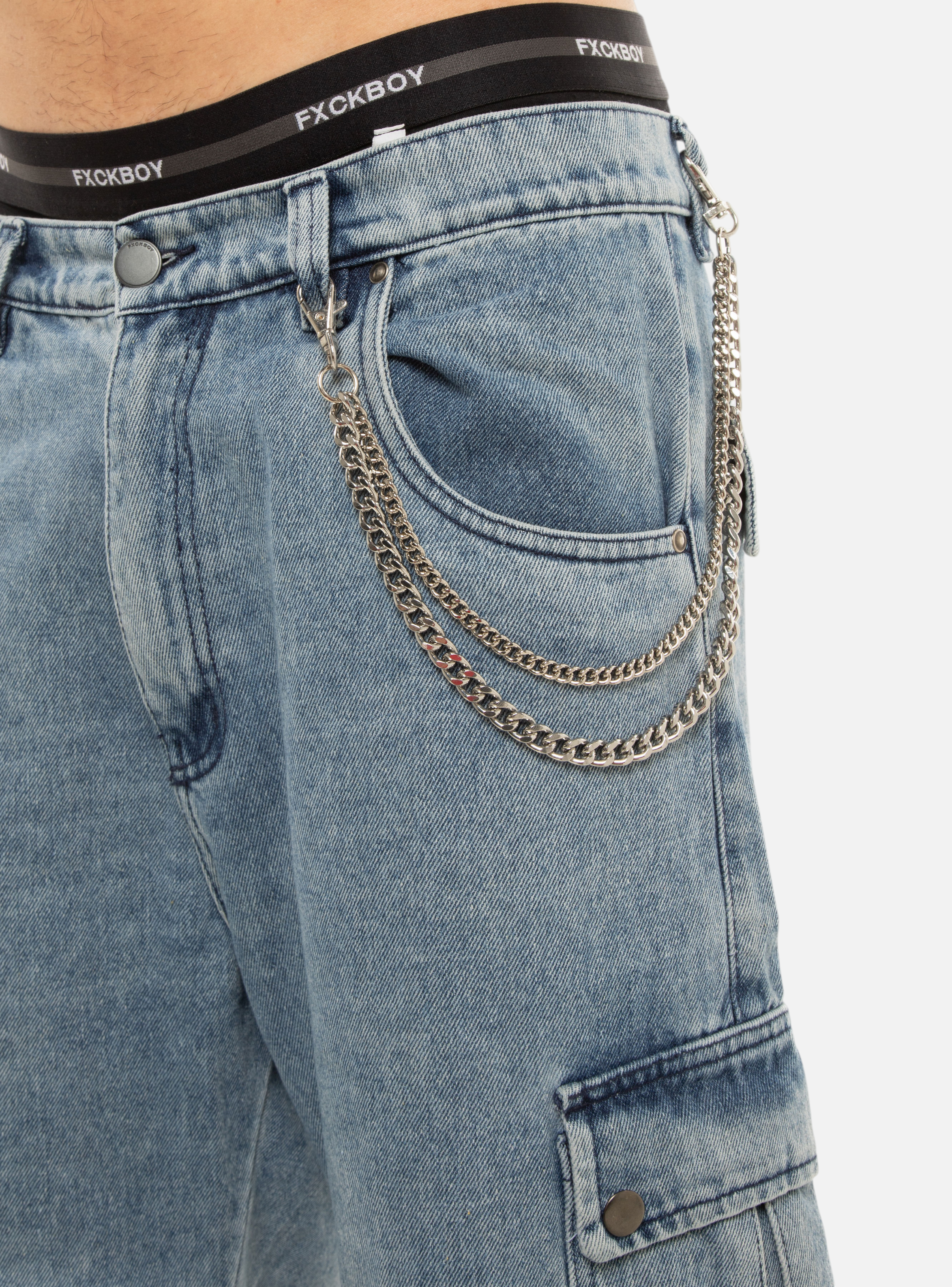 Fxckboy silver double chain accessory with Cuban and fine links, attached to light wash denim jeans.